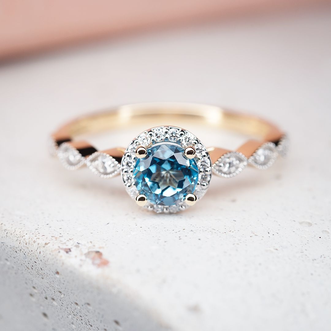 Złoty pierścionek z niebieskim topazem i diamentami